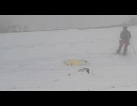 guy walking in snow and dragging board 