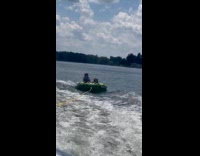 Kid bounced on the pulled inflatable tub