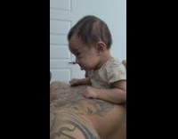 Baby tries not to cry while dad comforts him