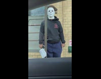 Man standing next to street sign as michael meyers