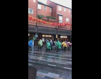 Large group of poncho ladies chant 