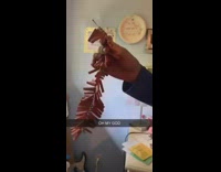 Guy lights fire cracker in house and drops it on floor and walks away