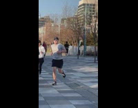 Man Jogs Barefoot at Park Pavement Walkway