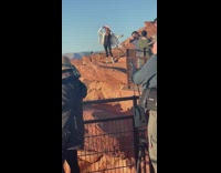 Woman with pink hat poses on the canyon cliff