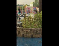 Man and woman photoshoot amusement park stopped by a guard