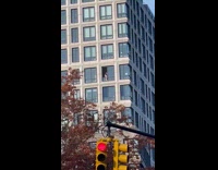 Man cleans window of his apartment day in NYC 