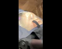 Baby face pressed up on clear top of stroller