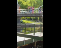 Three girls green blue pink bridge park
