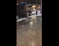 woman in leopard print snow suit walking with skis