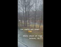 Car slides on icy road and woman says she is calling 911