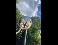 Guy pushes on squishy blind spot mirror 