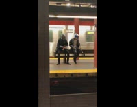 Two guys waiting for subway wear star wars helmets 