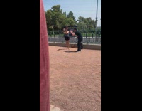 Black shirt guy photographs girl gnome dirt