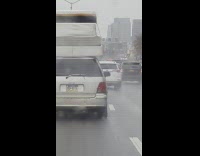 Station wagon carries layers of mattresses without rope