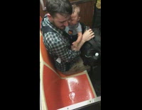 train leaking water next to man with baby