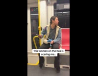 Woman barks inside bus stares at filmer