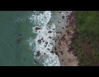 Aerial shot beach shore with large rocks