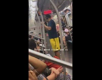 Guy holding drink dances in subway 