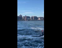 Scary clown driving jetski near Williamsburg bridge