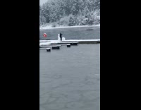 Guy shorts smash snowman swim frozen lake