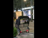 Woman in catwoman costume on tourist bike