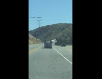 Three men peek out car window road