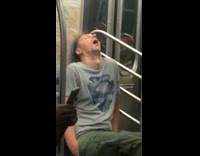 man in grey shirt asleep with mouth wide open 