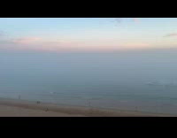 Thick fog surrounds the beach at sunrise 