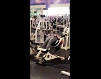Grey leggings girl uses exercise machine wrong