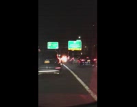 Cars drive by car fire freeway night 