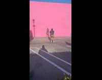 Guy floral shirt pretend pee pink wall