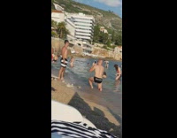 Guy striped trunks shades stand pose beach