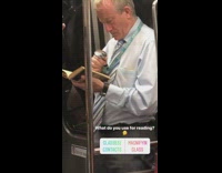 Man in business clothes reads book with magnifying glass on subway train