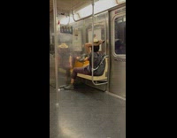Guy dances with cowboy hat in subway seat 