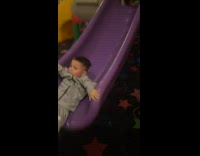Boy goes down slide while laying on stomach does scorpion 