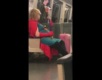 man dressed as superman on train