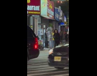 Man in prison costume dancing in front of store