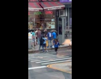 Four men punches each other on sidewalk