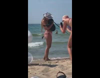 Lady in cowboy hat and bikini takes photo with dog 