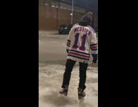 Guy skates on ice on road 