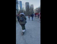 Dog rides along on back of person riding bird scooter
