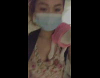 Girl walks with kitten wearing sweater on shoulder 