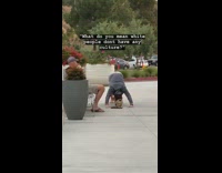 Guy does yoga stretches barefoot sidewalk 