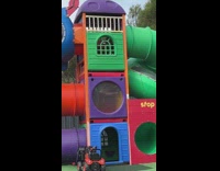Man waves hello inside playground 