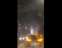 Pink red fireworks in street cause traffic 