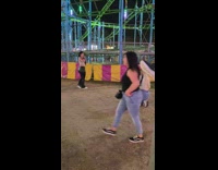 Woman flexes black leather pants at the Amusement Park