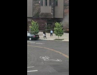 Woman blue jacket tiktok dance video sidewalk