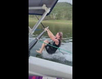Woman hangs off the side of boat falls