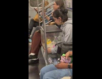 Woman holds aquarium with hamster inside at train NY