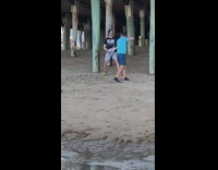 Man guitar hero toy guitar video shoot beach